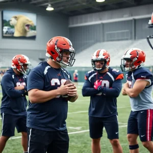 Football players practicing under the guidance of a coach at Oklahoma's training facility.
